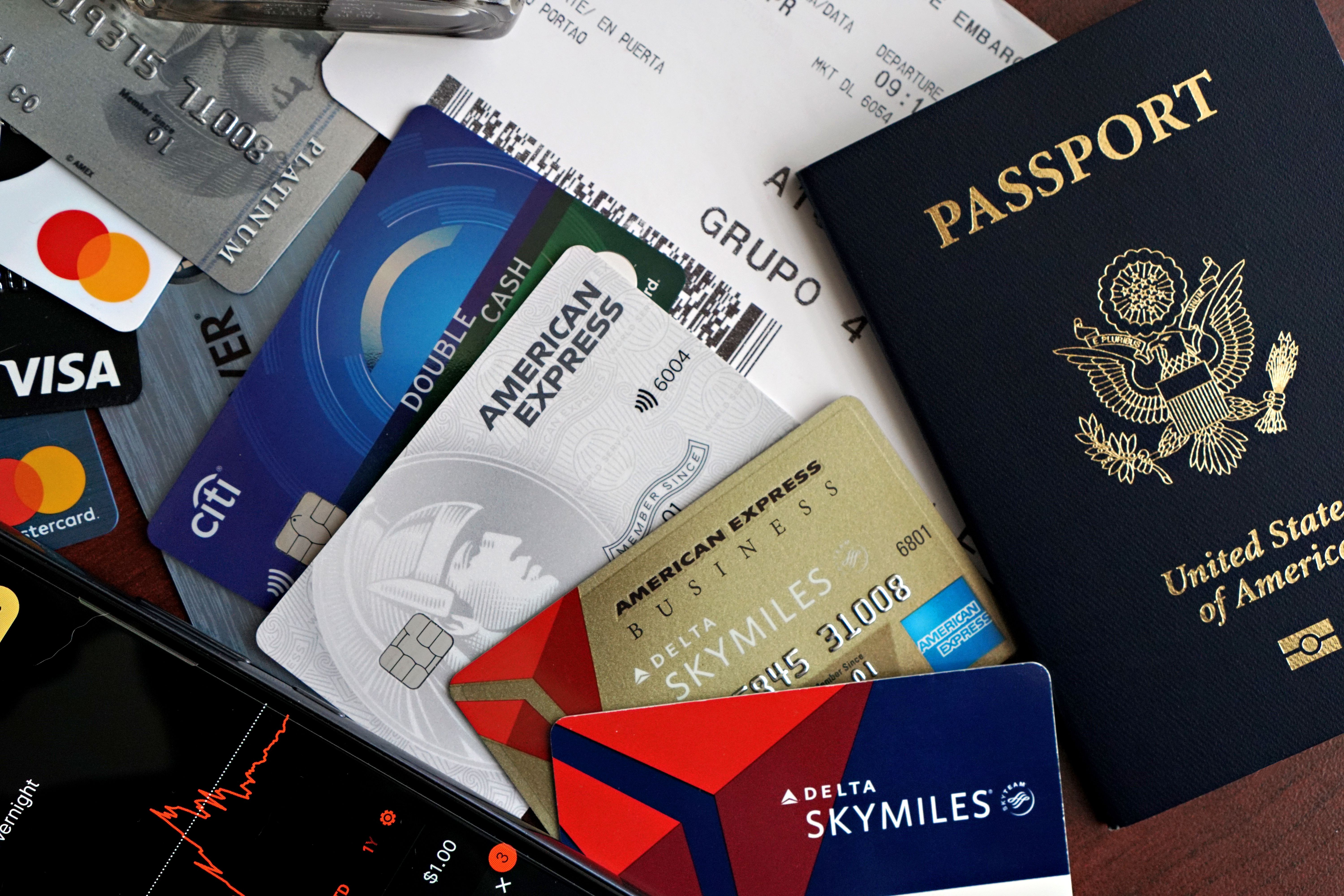 Travel rewards credit cards and airline loyalty program cards spread on table