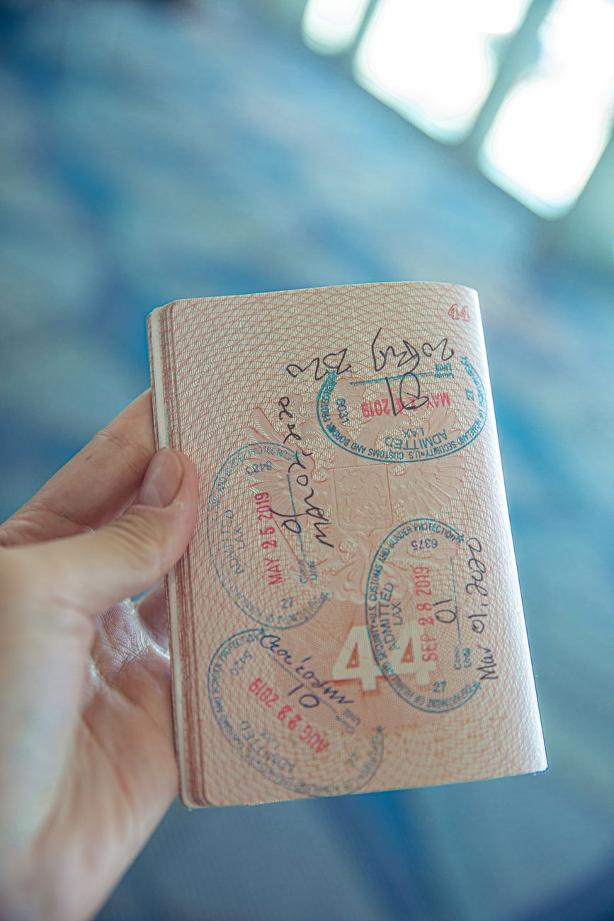 Close-up of an open passport displaying travel stamps — visa requirements for international travel
