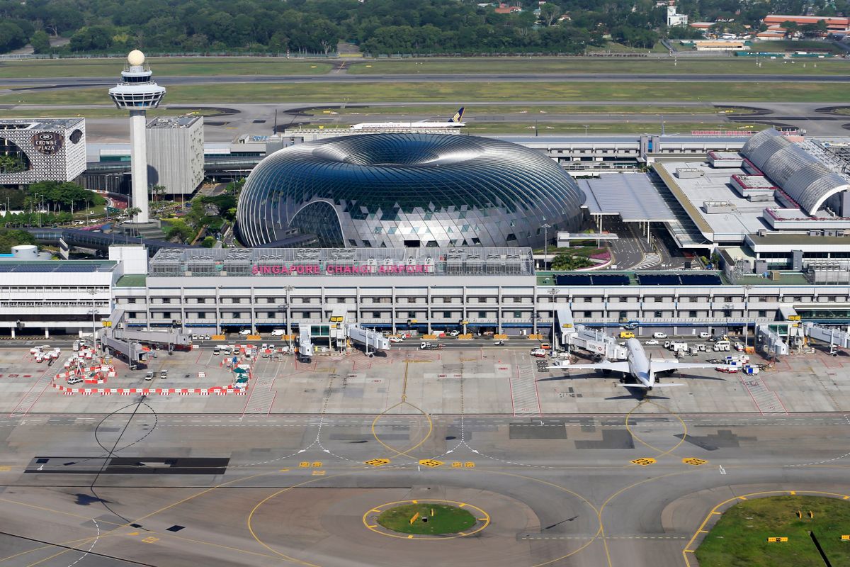 Aerial view of Singapore Changi Airport terminal complex with runway and parked aircraft