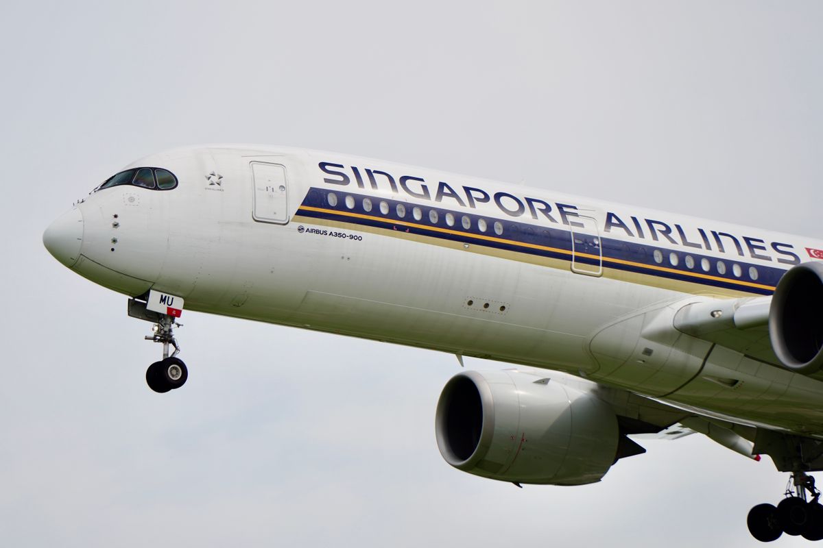 Singapore Airlines Airbus A350-900 aircraft in flight against a cloudy sky